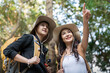 © Natee Meepian - Lovely couple lesbian woman with backpack hiking in nature. Loving LGBT romantic moment in mountains