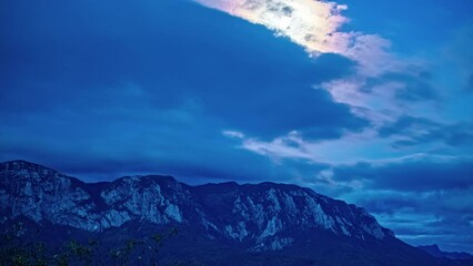 Wall Mural - night timelapse of the full moon moving along a mountain range