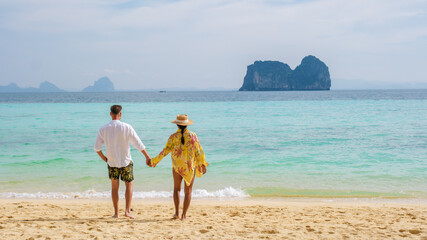 Wall Mural - happy young couple Asian woman and European men on the beach of Koh Ngai island in Thailand