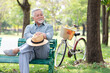 elderly man sitting on bench in the park