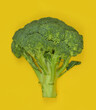 Broccoli on a yellow background, abstract, health, calories, diet. Top view. 