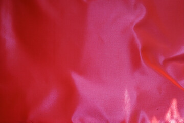 Wall Mural - Vibrant reddish pink satin polyester fabric from above