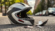 Close-up of a broken motorcycle helmet lying on the asphalt of a road after an accident. Generative Ai.