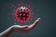 Hand holding red virus model for illustration in health concept