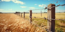 A Picture Of A Wooden Fence Standing In A Field Of Tall Grass. This Image Can Be Used To Depict Rural Landscapes, Nature, Or Even Concepts Like Boundaries And Solitude