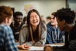 © Marharyta Tsapenko - Group of high school students laughing together during classroom activity.
