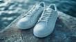 A pair of white sneakers on a clean surface, highlighting the classic and versatile nature of athletic footwear