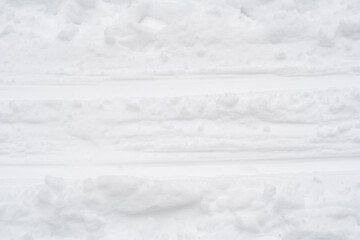 Close-up of ski marks in the snow. Background on the theme of sports and a healthy lifestyle in winter.