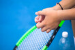 close-up of the hands of a female tennis player holding a tennis racket 