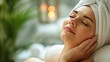 © Anzhela - Young woman with closed eyes enjoying beauty treatments in spa salon