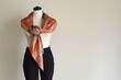 silk scarf on mannequin tied in kimonostyle with black pants