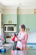 © Austockphoto - Middle aged woman in her kitchen making a cup of tea