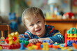 © johnalexandr - Cute boy with down syndrome plays with toys while sitting at the table