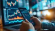 © Amonthep - Businessman Holding Smartphone and Checking Stock and Cryptocurrency Market in Office.