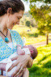 © Austockphoto - Mother looking at her newborn daughter smiling outside