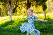 © Austockphoto - Six year old girl twirling outside in blue dress