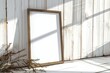 thin a3 sized frame mockup leaning against a white wooden wall, reflections of windows, tilted side view