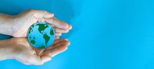 hand holding paper cut saving clean energy earth globe world environment green eco friendly, save pl