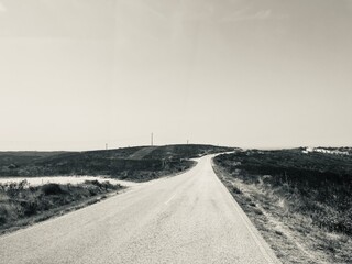 Wall Mural - Driving empty country road to the ocean coast