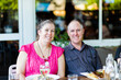 © Austockphoto - Happy middle aged couple eating meal together at restaurant