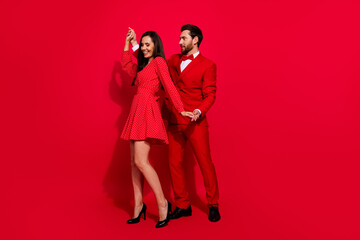 Poster - Full body photo of attractive young couple dancing have fun valentine day wear trendy elegant clothes isolated on red color background