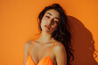 © Studio Vision - sexy Beautiful young woman in tank swimsuit on orange background