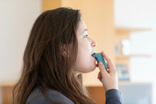 Young Woman Using An Inhaler