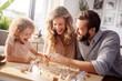 A happy family playing a board game at home. Concept of educational games for a child