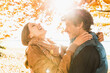 © MACO - Couple embracing in a park in the fall with lake in background. Starnberg, Germany