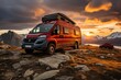 Modern red camper parked in the mountains at sunset,  warm glow over the sky. travel concept