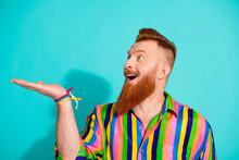 Photo Of Young Surprised Businessman Introducing On His Arm Holding Hair Lotion For His Red Hairstyle And Beard Over Blue Color Background