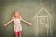 © MACO - Young girl drawing on a wall with chalk.