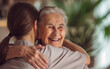 © Giordano Aita - An elderly woman smiles with joy as she hugs her grandson