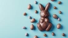 Easter Chocolate In The Shape Of A Bunny On Blue Background - Easter Concept Backdrop With Copyspace
