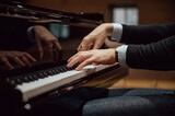Fototapeta Przestrzenne - Low angle view of hands of a pianist playing pian