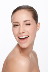 Canvas Print - Portrait, smile and woman wink for skincare, flirt or natural beauty isolated on white studio background. Face, blink and happy model in cosmetics excited for spa facial treatment for healthy skin