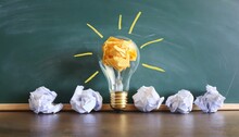 Education Concept Image Creative Idea And Innovation Crumpled Paper As Light Bulb Metaphor Over Blackboard