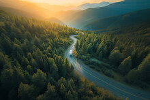 Recreational Vehicle Driving In The Mountains During Sunset