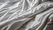 white wrinkled fabic texture rippled surface close up unmade bed sheet in the bedroom after night sleep soft focus