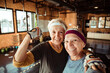 © Davor - Two smiling senior women taking selfie in gym