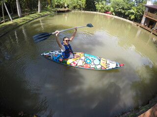 Wall Mural - jovem mulher sorridente em canoa no lago 