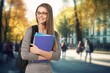 © BillionPhotos.com - Happy young woman student outside at college.