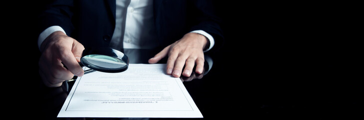 Poster - a man in a suit holding a magnifying glass