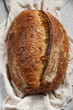 Crispy traditional rustic sourdough wheat bread on a towel, top view