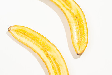 Two half of a banana on white background. Delicious and healthy fruit