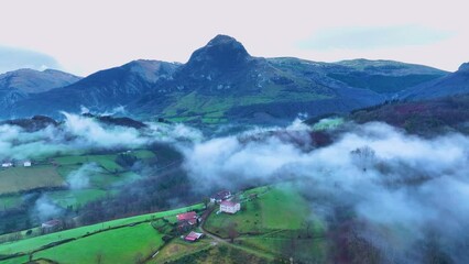 Wall Mural - Aerial drone view of the winter landscape around the town of Gainza and Amezqueta and the Txindoki Mountain. Aralar Mountain Range. Goierri region. Gipuzkoa. Basque Country. Spain. Europe