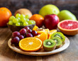 Sliced fresh fruits on wooden serving board