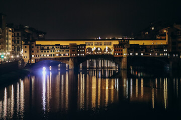 Wall Mural - The Ponte Vecchio at night, a medieval stone closed-spandrel segmental arch bridge over the Arno, in Florence, Italy