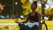 Young disabled black woman in a wheelchair relaxing and practicing wellness and meditation yoga outdoors in a sunny nature park. Inclusive and diverse exercise and wellness. AI generated