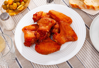 Poster - Crispy smoked chicken wings served in a flat plate with other table appointments